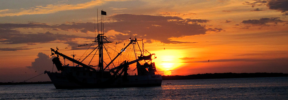 Ship on the middle of the sea during sunset